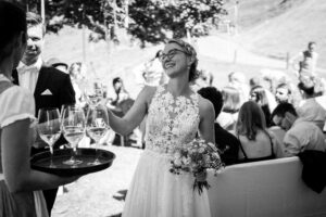 Black-and-white photo of the wedding couple toasting with champagne glasses