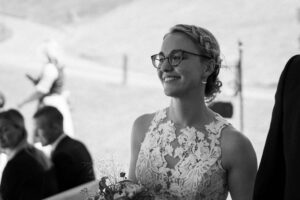 Black-and-white close-up of the bride walking into the ceremony