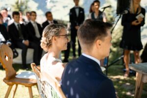 Side portrait of the bride laughing during the ceremony