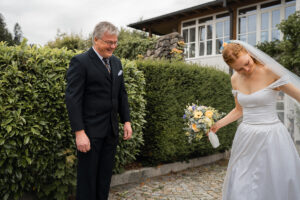The father smiles proudly as he admires his daughter's beauty
