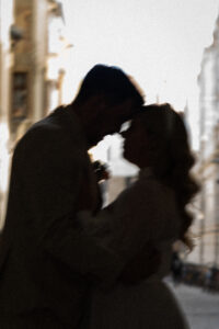 Slightly blurred silhouette photo of a couple leaning their heads together