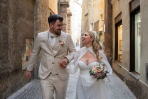 Wedding couple walking forward while smiling warmly at each other