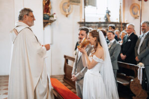 The bride drinks from the chalice presented by the priest