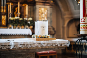 Close-up of the wedding candle placed on the church altar