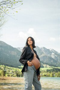 Vintage photo of a young pregnant woman in front of the Wilder Kaiser and Lake Walchsee