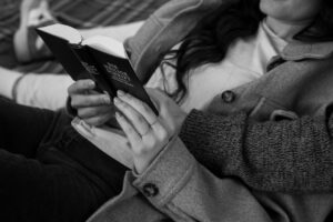 Black-and-white detail photo of a young religious couple reading the Bible together