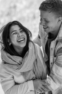 Slightly blurry black-and-white photo of a man making his partner laugh