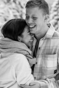 Slightly blurry black-and-white photo of a young couple embracing closely
