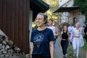 The bride walks toward the ceremony location in casual clothes, smiling brightly