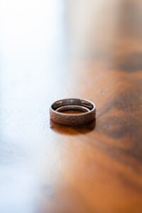 Close-up of wedding rings resting together with the engraving visible