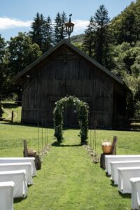 Photo of the white benches and floral ceremony arch