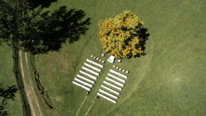 Drone photo of the ceremony location with a heart-shaped pattern mowed into the grass
