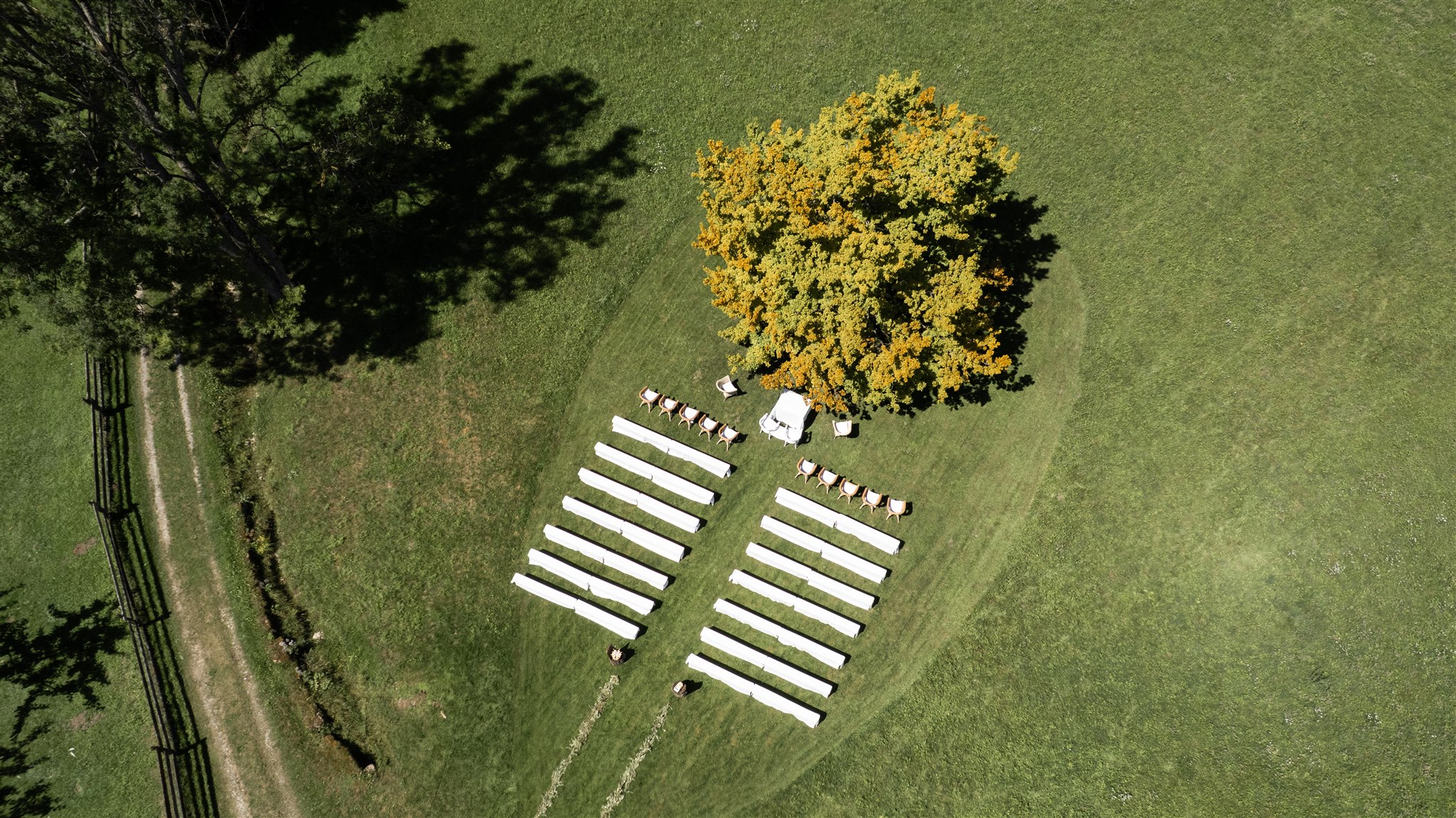 Drone photo of the ceremony location with a heart-shaped pattern mowed into the grass