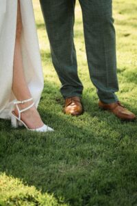 Close-up of the wedding shoes on a meadow