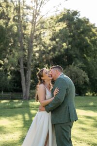 Mid-range shot of the groom kissing his bride on the cheek