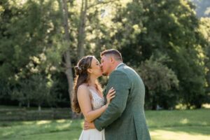 Close-up of the bride and groom kissing in golden backlight