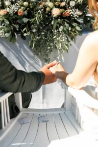 Close-up of the wedding couple holding hands