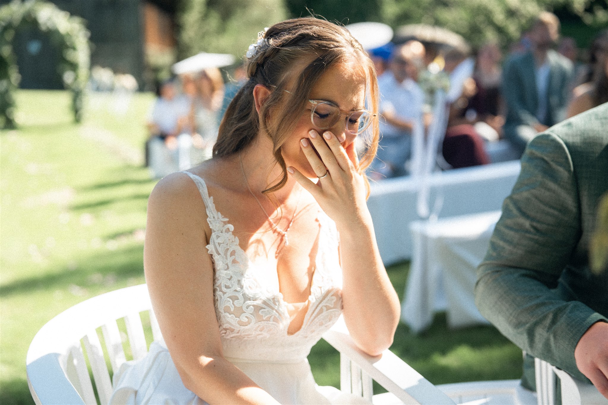 Close-up of a happy bride laughing with her hand in front of her mouth