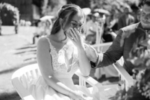 Black-and-white portrait of the bride smiling emotionally during the ceremony