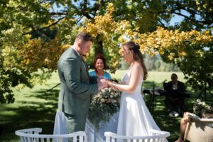 Bride and groom laugh at each other before their kiss