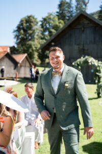 Portrait of the groom walking toward the ceremony location