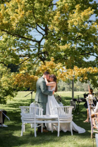 Wedding kiss beneath a large tree