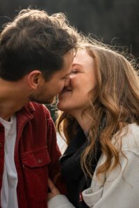 Close-up of a young couple kissing in backlight